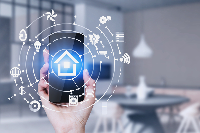 woman-hand-holding-smartphone-blurred-kitchen
